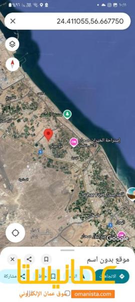 للبيع ارض سكنية تجارية في صحار الملتقى بالقرب من منازل قائمة ومن